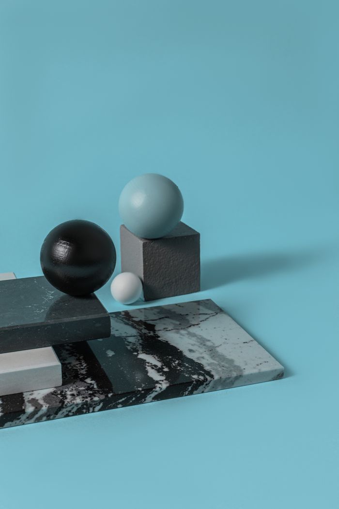 Mastering the First Impression: Your intriguing post title goes here Artistic arrangement of spheres and blocks on turquoise background.